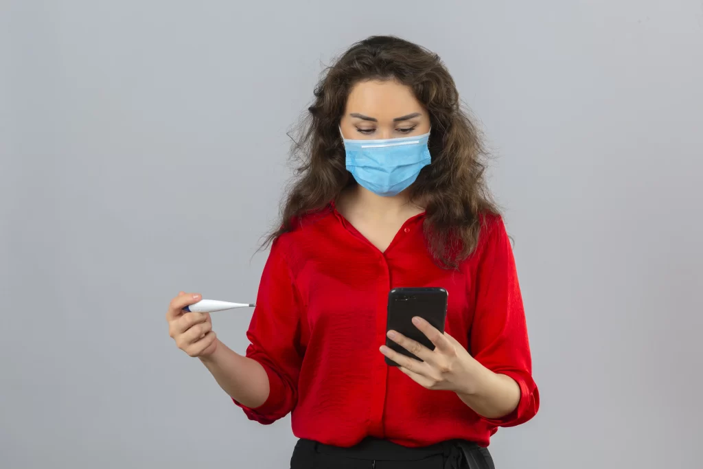 a patient checking her fever and consulting on healthcare app online- digital healthcare